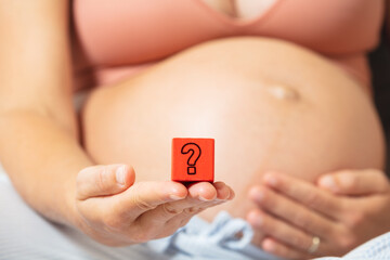 Question on pregnancy concept woman hold block