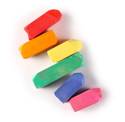 Colorful chalks arranged as LGBT rainbow flag isolated on white background, top view