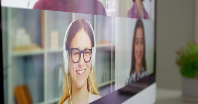 Close-up of talking friends or colleagues at the computer screen. Online meeting, remote video call. An educational webinar for students using a webcam. 4K.