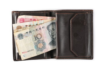 Chinese yuan bills in old brown leather wallet isolated on white background, top view