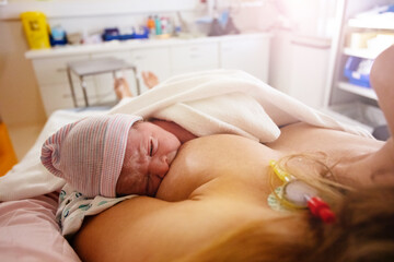Obraz na płótnie Canvas Close photo of mother breast feeding newborn baby
