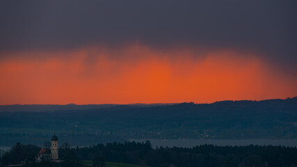 burning sky at sunset with thick and dark clouds