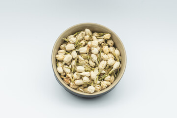 lot of dry jasmine in bowl isolated on white background