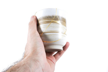 Beige Kintsugi tea cup, Japanese broken. pottery 