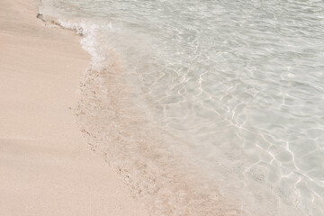 Waves of Mediterranean sea. White fine sand beach and clear turquoise water. Beautiful Mallorca coastline landscape. Balearic island, Spain, Europe. Summer travel concept, tourist destination.