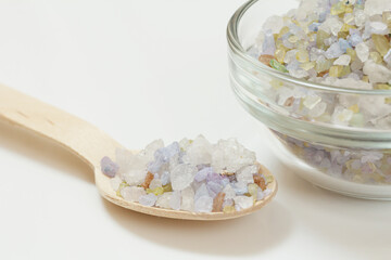 Wooden spoon and glass bowl with sea salt.