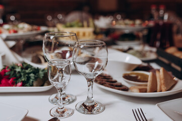 served table in the restaurant with glasses and food