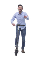 Fototapeta premium in full growth. happy young man with an electric scooter