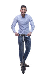 Naklejka premium in full growth. happy young man with an electric scooter