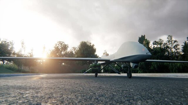 A military predator drone stands on the road and prepares for takeoff. The animation is for military, the weapon or spying backgrounds. View of a military drone spy ready for military action.