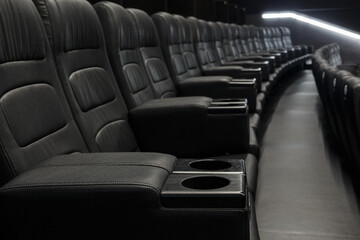 Empty Black Leather Seats In Row At Movie Theater