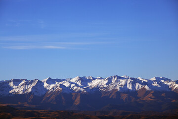 Fototapeta na wymiar Mountains with Snow-Capped Peaks. The Concept Of Travel And Tourism. Background