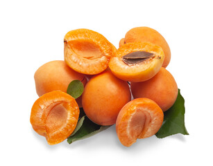 Group of whole and half apricots with green leaves on a white background.