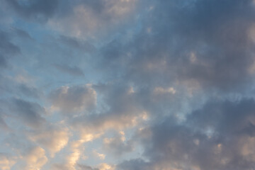Beautiful sunset sky with multi-colored fluffy cumulus clouds. Heavenly background for your photos