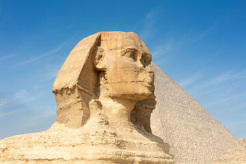Fototapeta na wymiar Great profile of Sphinx pyramid with the blue sky background.
