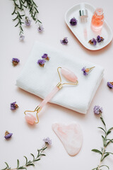 Gua sha beauty roller and rose facial serum, top view