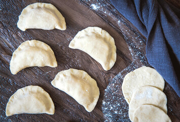 Raw dumpling with potatoes. Preparation dumplings on a wooden board