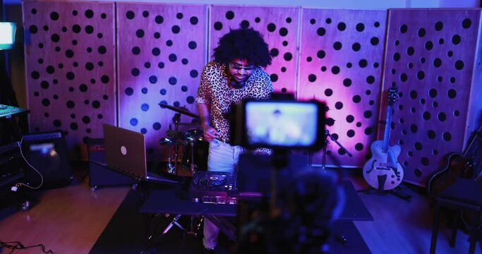 African dj man mixing new album inside boutique recording studio while streaming live concert