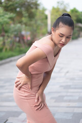 asian woman suffering from hip joint pain, pelvic hip joint dislocation, arthritis, gout symptoms