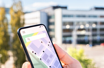 Map in phone with city street network and place pointers. Location of restaurant, hotel, taxi or...