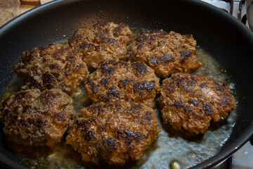 ready homemade burger meatballs are cooked in a cast iron pan. Selective Focus Burger meatballs.