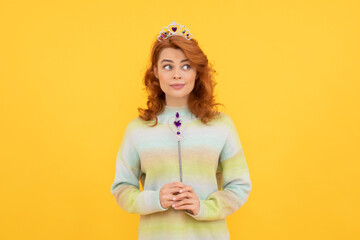 surprised redhead woman in queen crown with magic wand, magic