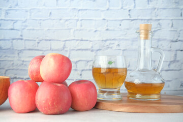 apple vinegar in glass bottle with fresh green apple on table 