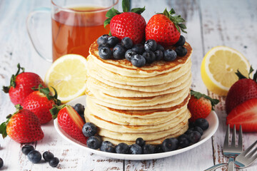 A stack if home-made pancakes with berry