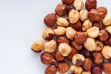 fresh natural hazelnuts on a white acrylic background