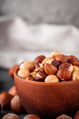 Fototapeta premium fresh natural hazelnuts on a dark stone background