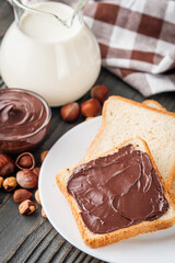 toasts with chocolate butter on a dark wooden rustic background