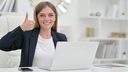 Thumbs Up by Positive Young Businesswoman working in Office 