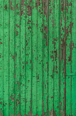 Wooden boards with old green paint close-up.