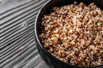bowl of healthy quinoa on a dark wooden rustic background