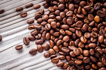 aromatic fresh coffee beans on a white wooden rustic background
