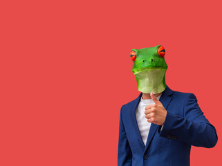 man with googly-eyed frog mask making a like or thumbs-up on red background