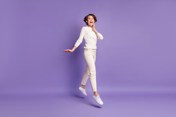 Full length body size photo of happy girl bob hair jumping touching cheek smiling isolated on pastel purple color background