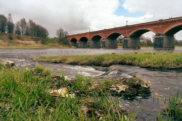 Landscape with Venta river and old Kuldiga brick bridge