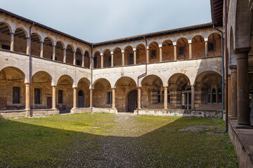 Fototapeta na wymiar Old arcade courtyard of the former Saint Augustin monastery (Ex monastero di Sant'Agostino), now is the University of Bergamo. Italy.