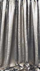 Silver curtain. Gray stage silk fabric. Beautiful glamour background.
