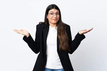 Business woman over isolated white background having doubts with confuse face expression