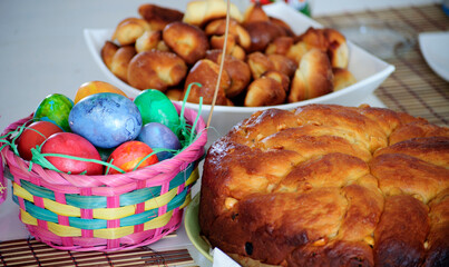 Different colors
Easter eggs in a colorful basket, homemade Easter cakes and rolls.