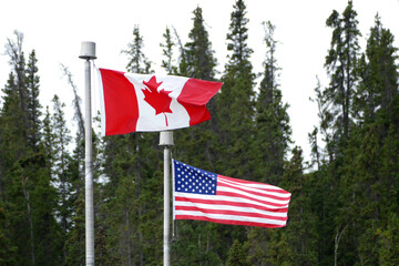 Canada and United States friendship partnership flags on posts on borders, USA