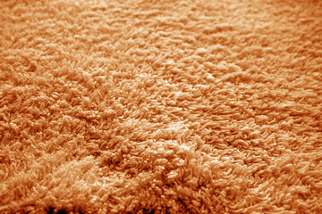 Bath towel texture with blur effect in orange color.