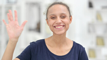 Portrait of Cheerful African Woman Waving at the Camera 