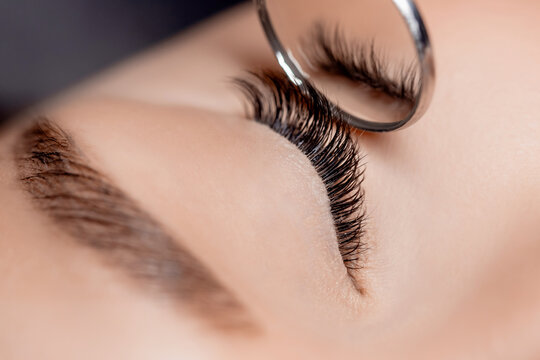 Eyelash extension procedure. Classic volume black fake long lashes beautiful female eyes