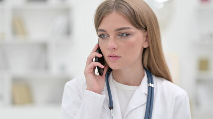 Portrait of Professional Young Doctor Talking on Phone 