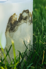homemade multi-colored candles with concrete on a background of green grass. handmade decor close-up. Details of a colored cube and tube loft candle