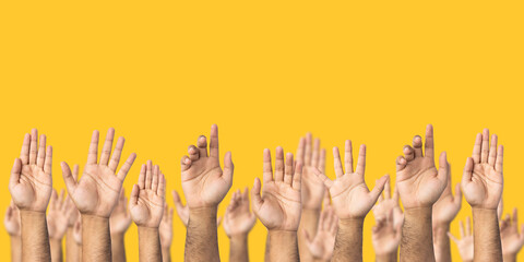 A lot of hand raised up to the air isolated yellow background. Raise your hand to vote for the...