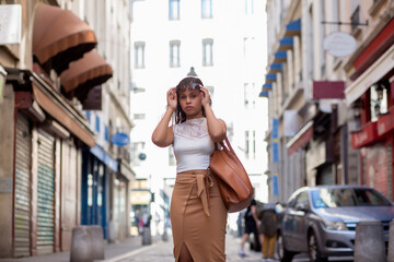 Fototapeta premium young latin american woman walking through the streets of the city of lyon france